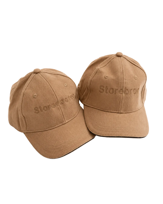 Barnecaps med teksten “Storebror"/"Storesøster”